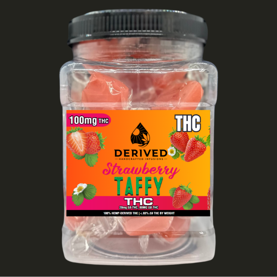 Jar of strawberry taffy labeled 'THC Derived Strawberry Taffy' with a black lid on a black background.